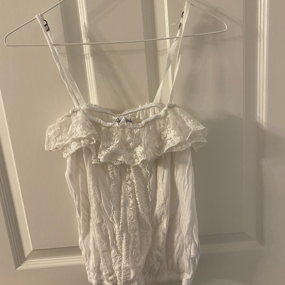 Cute spaghetti strap crop top with front tie drawstring. Size XS